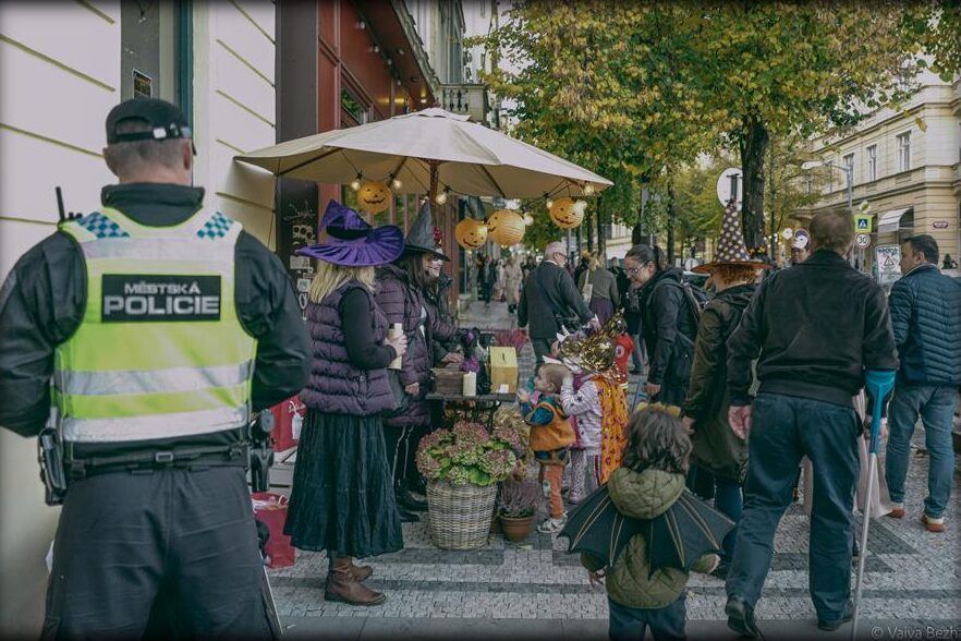 A street full of stops, families and a police officer keeping watch